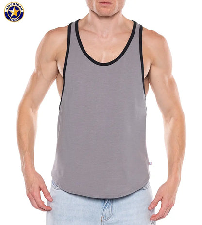 Men's platinum tank top with black trim made of soft material featuring a sleeveless design modeled by a man by AMERICAN JOCK