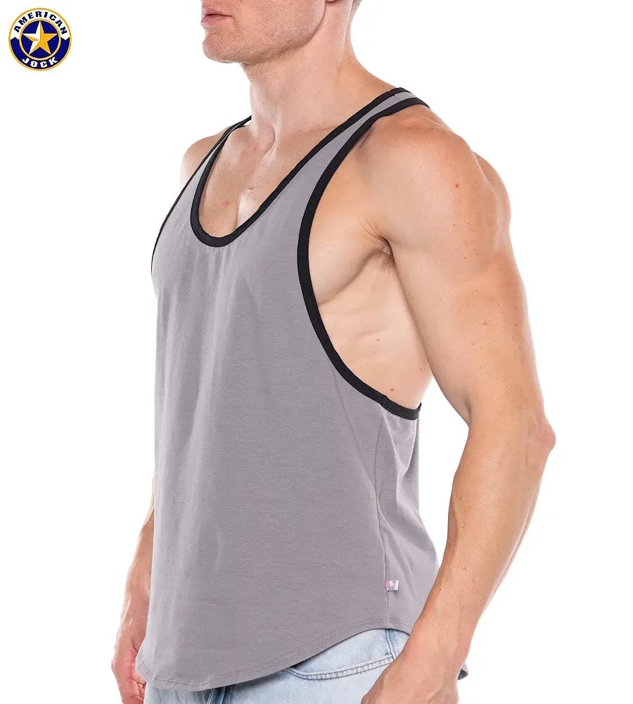 Men's platinum tank top by AMERICAN JOCK featuring a relaxed fit black trim and sleeveless design worn by a model from the side