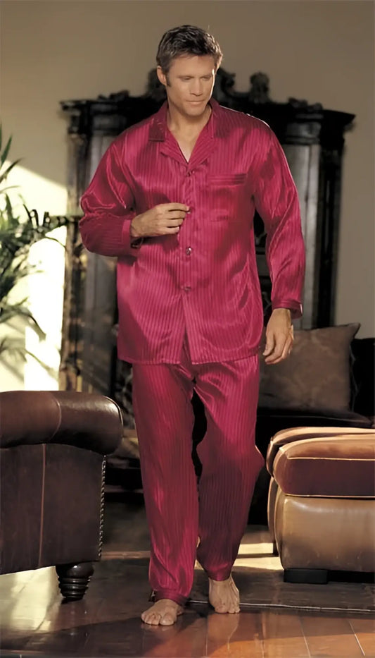 A man wearing a shiny deep red satin silky soft stripe pajama set in size small by Gyz