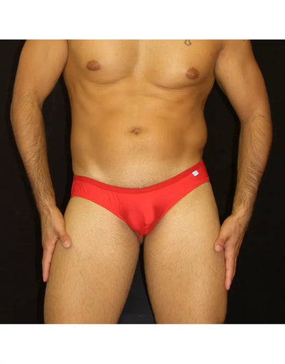 Red half bikini jockstrap underwear by Arroyman featuring a snug fit and smooth fabric shown on a model.
