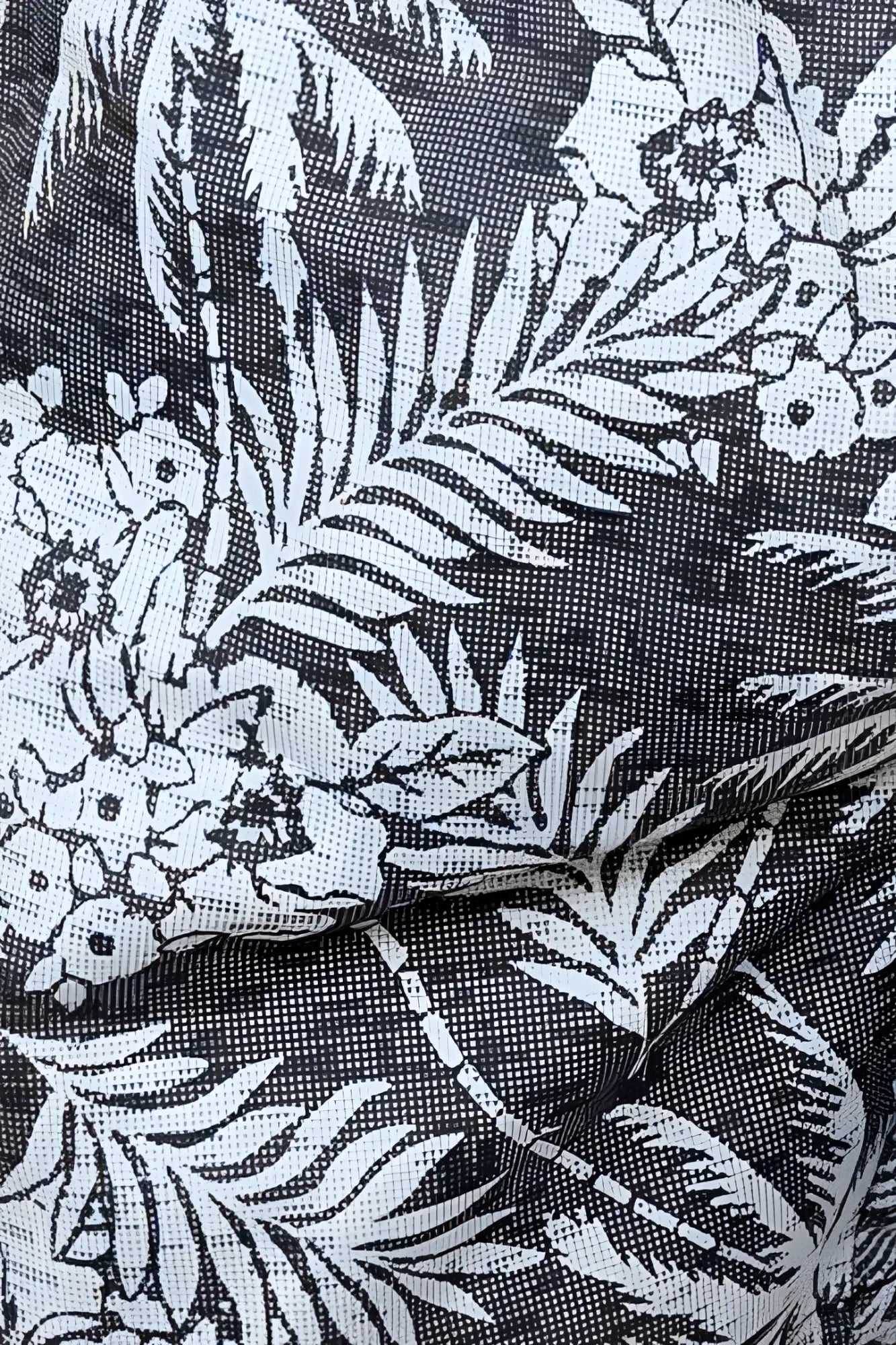 Black fabric hawaiian print swim short with white tropical palm trees flowers and leaves pattern