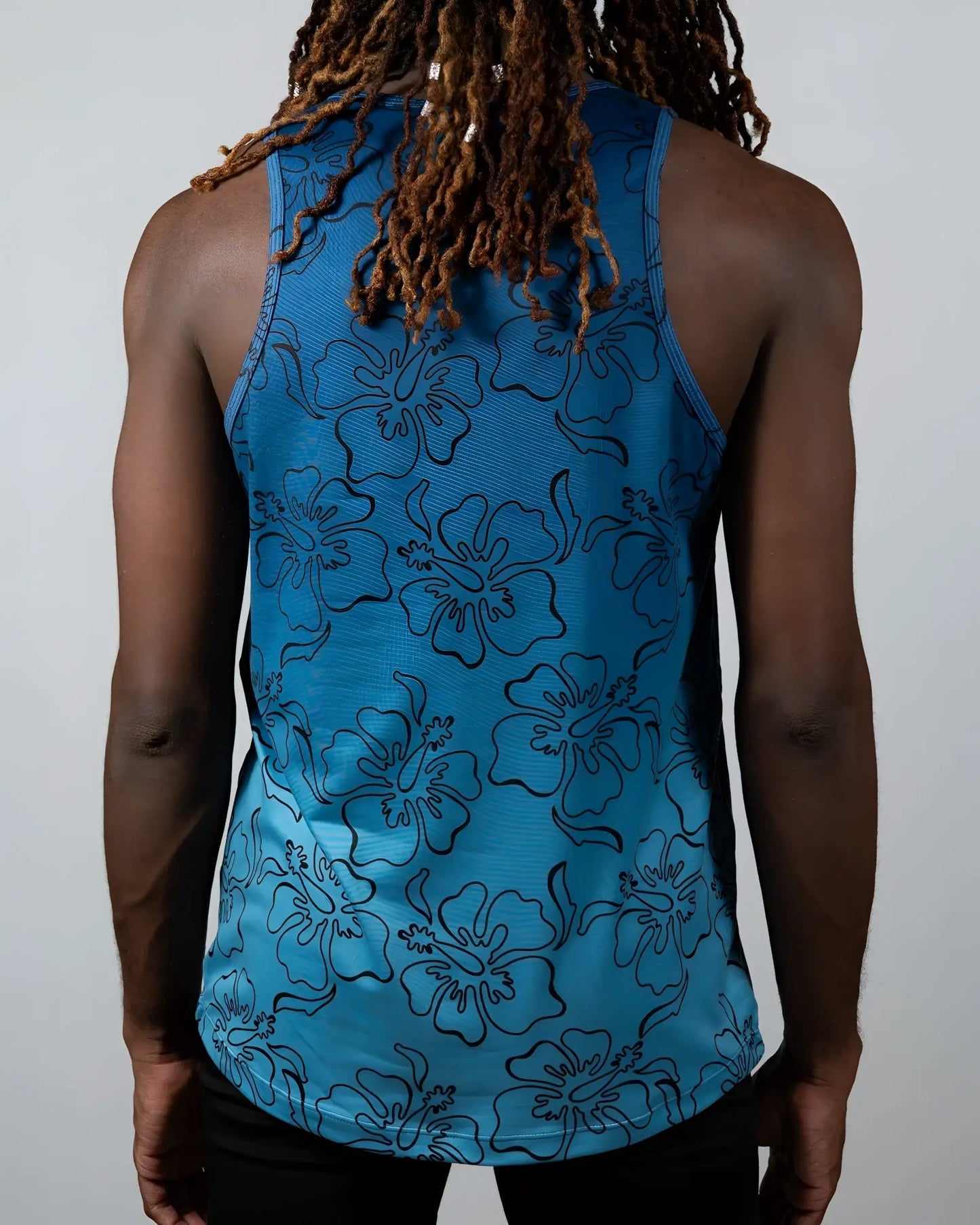Blue floral patterned tank top with black outlined hibiscus flowers in hibiscus ombre print tank design
