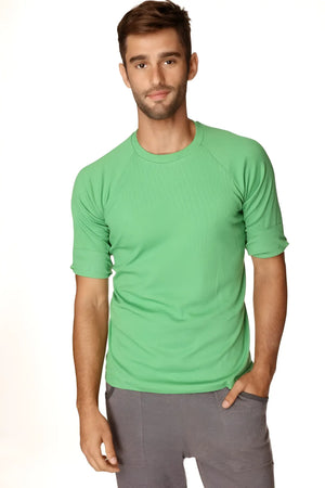 A men’s short-sleeved green athletic Hybrid crew neck raglan tee with ribbed texture rolled-up sleeves in bamboo green