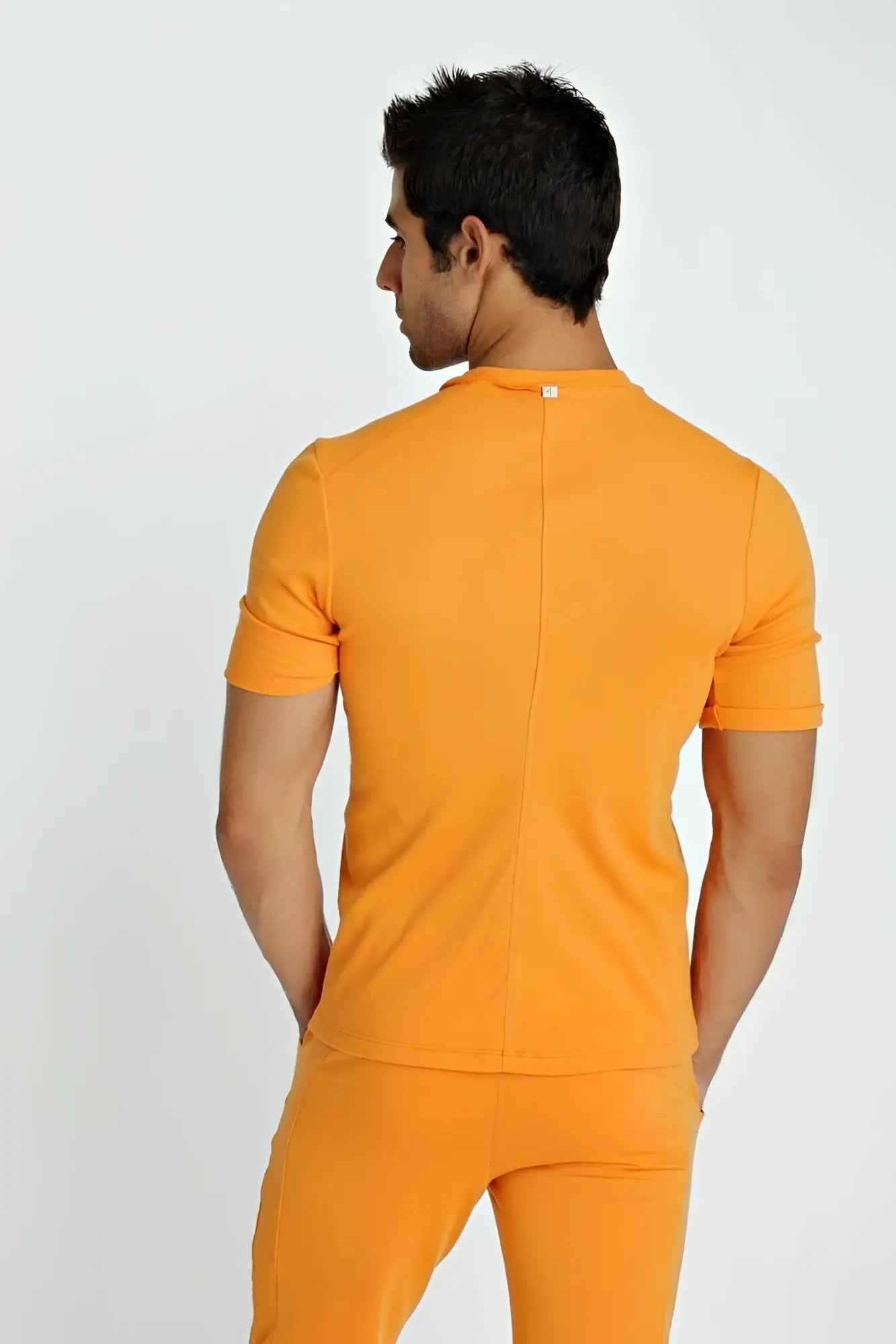 Orange short-sleeved fitted hybrid v-neck t-shirt back with central seam and subtle brand tag at neckline