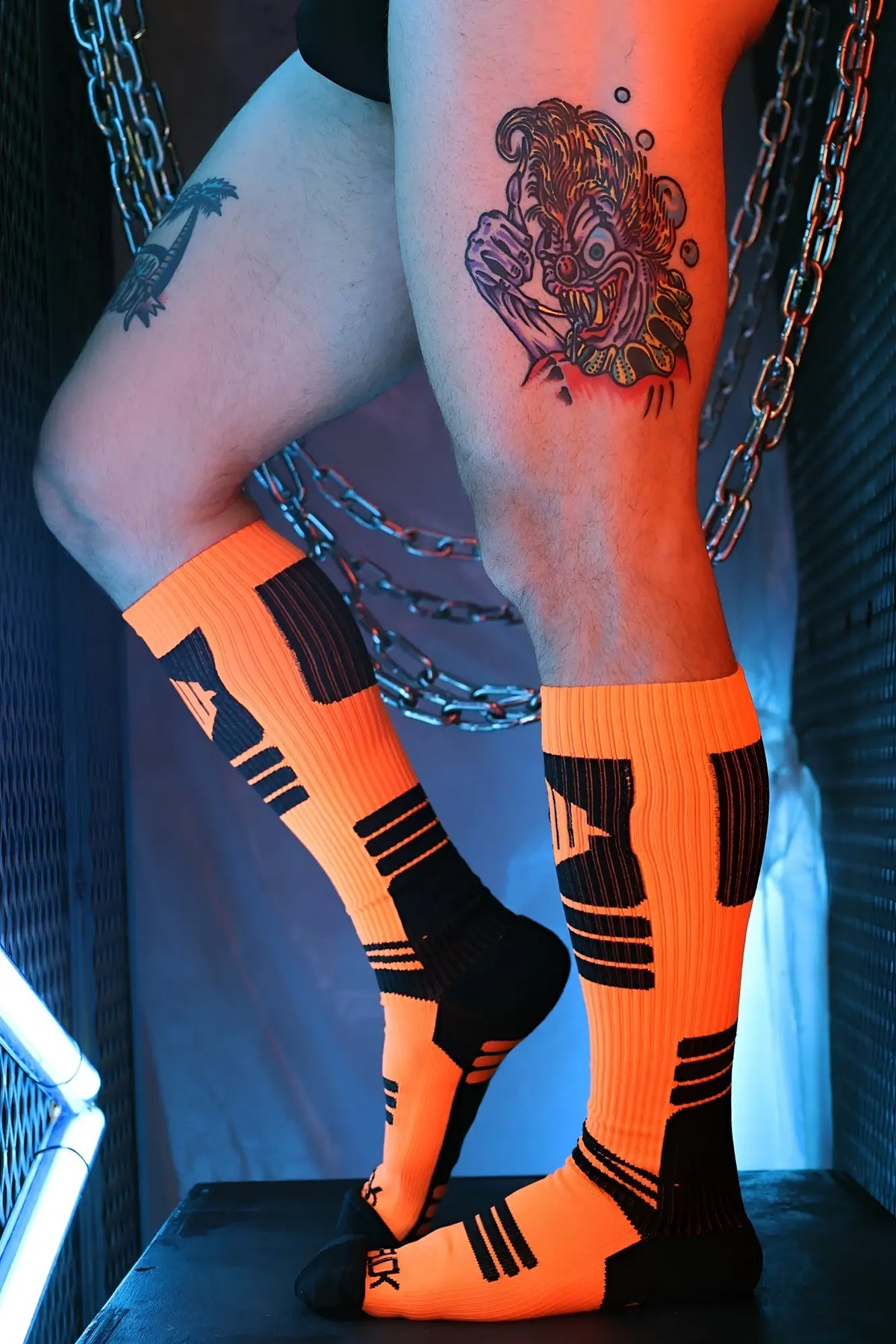 Hypnotix socks bright orange athletic socks with black geometric patterns and reinforced heel and toe sections