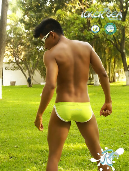Bright neon green icker sea micro slip bikini swim trunks with white contrast trim for swimming and beachwear