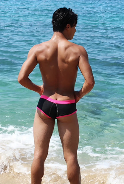 Black swim trunks with bright pink contrast trim and stitching from icker sea cheeky bikini swimwear collection