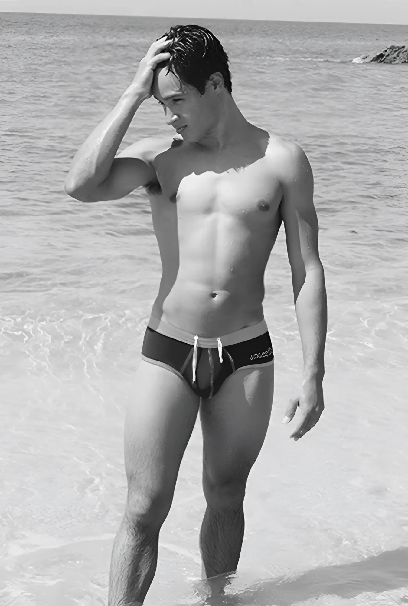 Black and white cheeky mini bikini swimwear with contrast trim stitching and light-colored waistband by Icker Sea