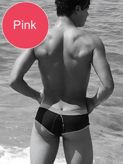 Black and white cheeky mini bikini swimwear with pink waistband and contrast trim by icker sea front view