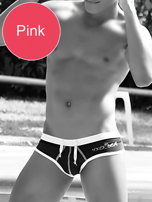 Pink swim trunks with white waistband and drawstring featuring vixen branding from icker sea cheeky mini bikini set