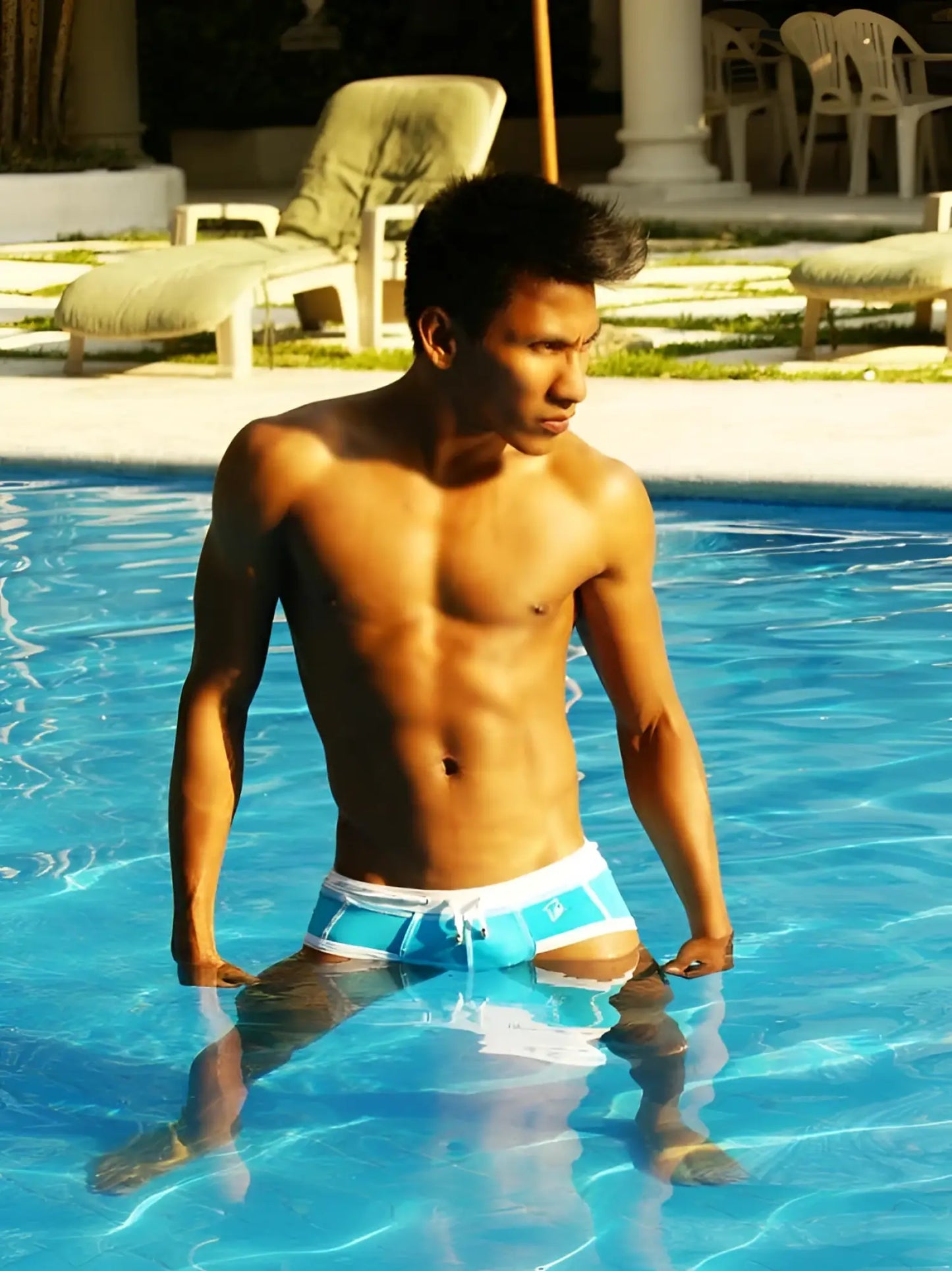 A man standing in a pool wearing icker sea cord contrast trim stitching bikini swimwear in blue and white
