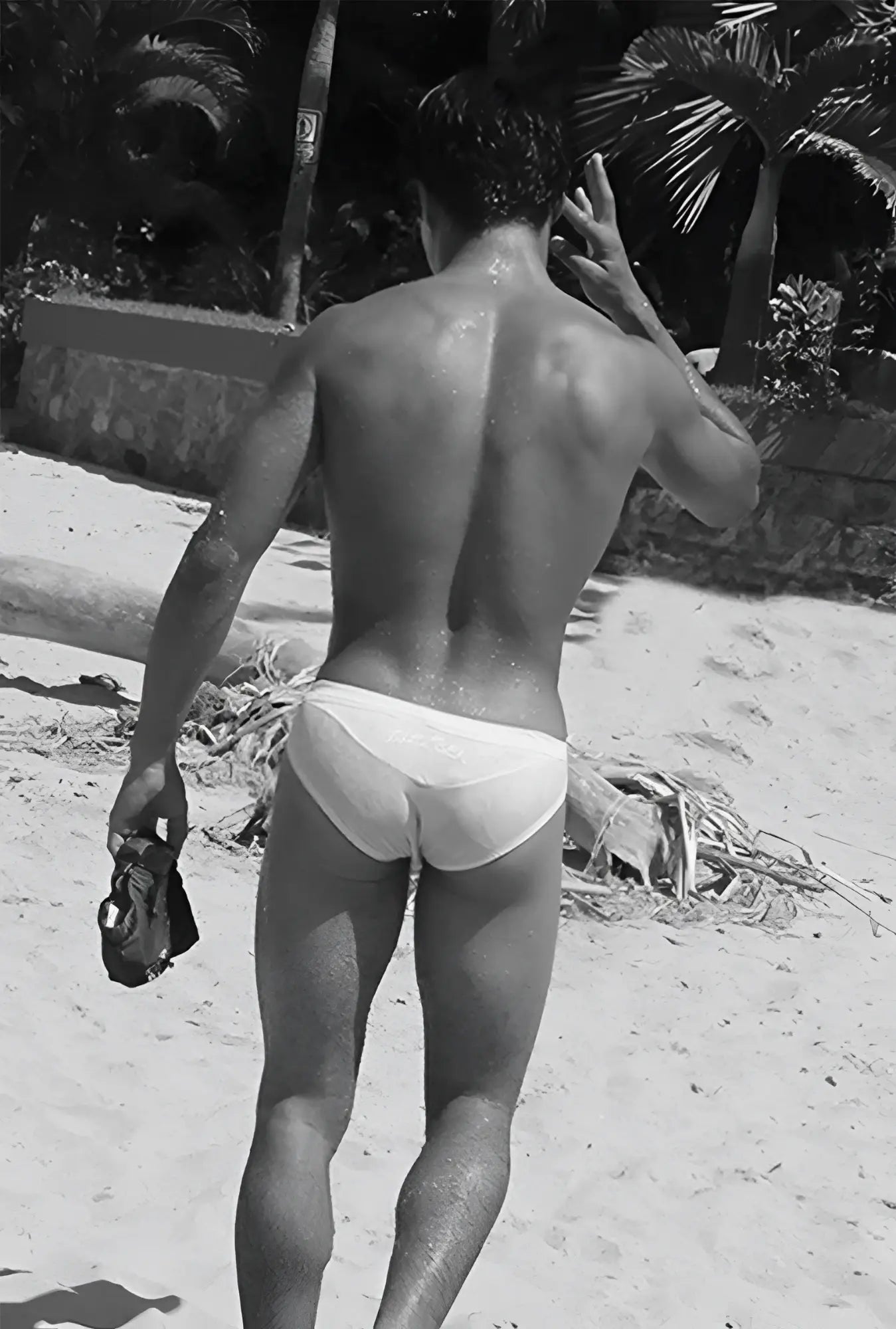 White briefs swimwear by icker sea in duotone blue worn by a man on a beach front view