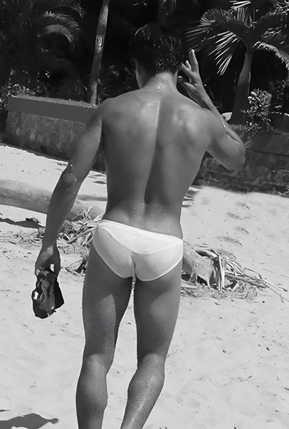 White briefs swimwear by icker sea in duotone blue worn by a man on a beach front view