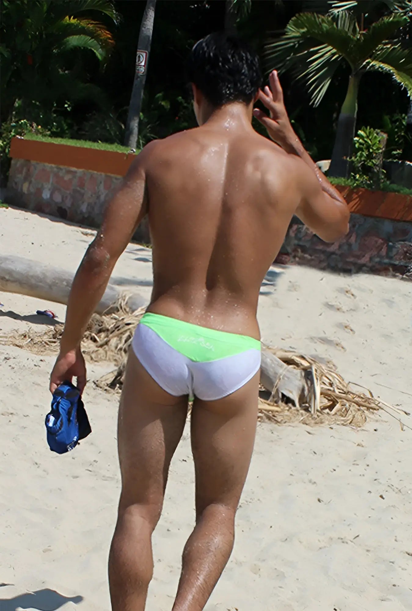 The back of icker sea duotone bikini swimwear green cob-15-22 swim trunks with lime green waistband and black fabric logo