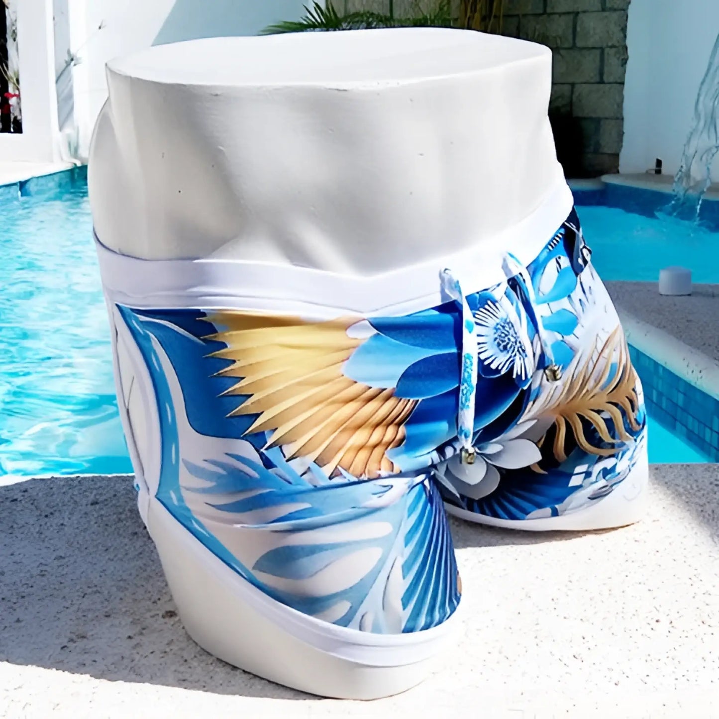 Icker Sea Greek Floral open side suspender scalloped shorts swimwear in blue white tropical print with gold accents on mannequin