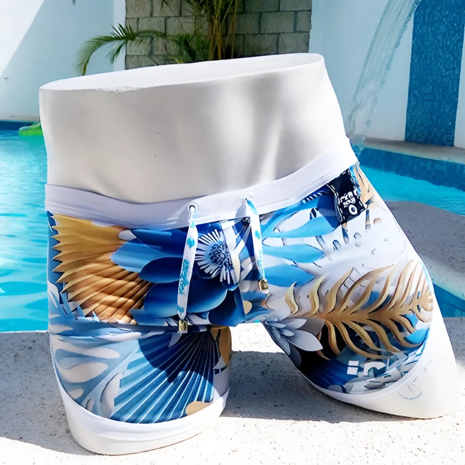 Icker Sea Greek Floral open side suspender scalloped swim shorts in blue and gold tropical print with white waistband
