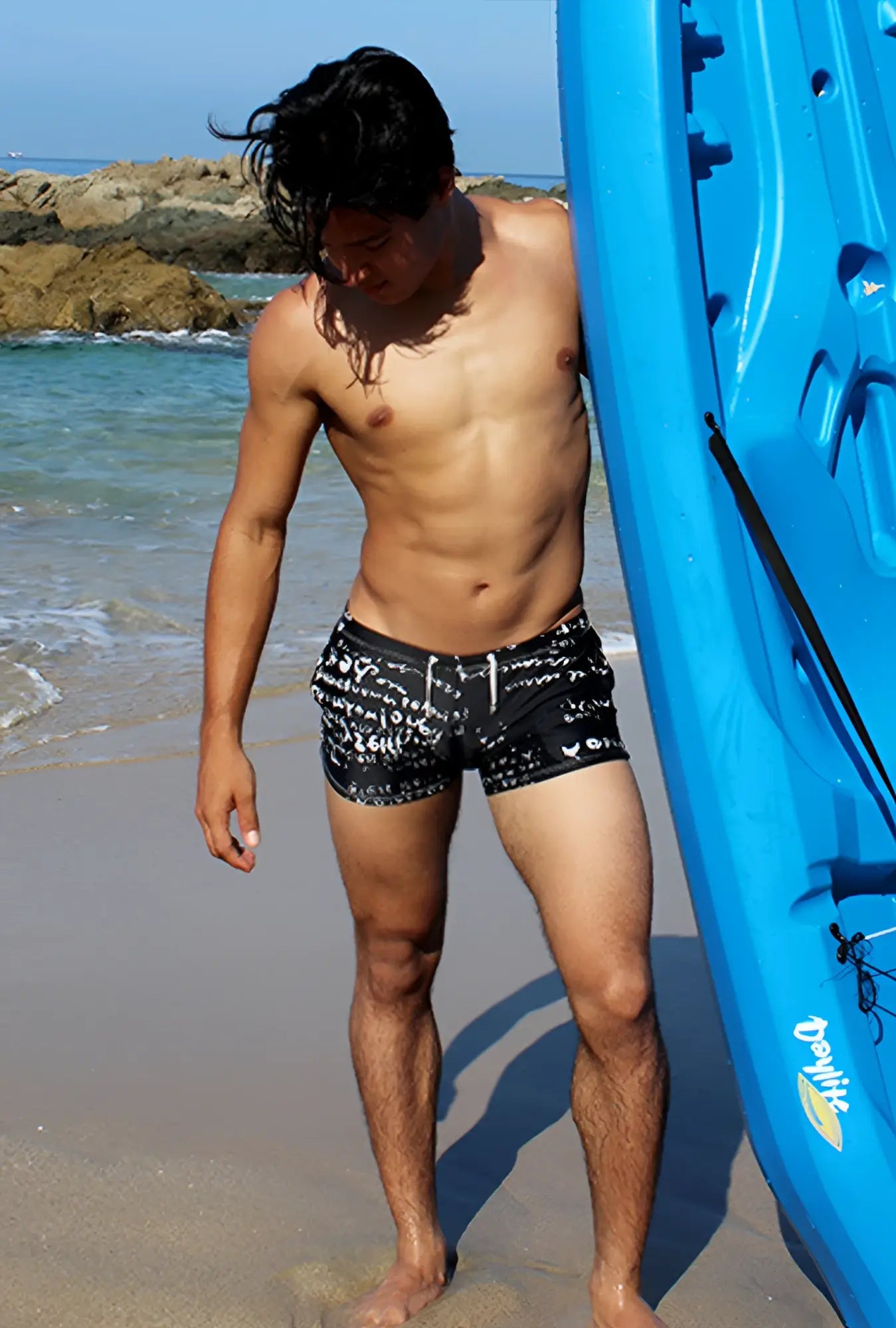 Icker Sea letters square cut black swim trunks with white graffiti lettering and a drawstring waistband