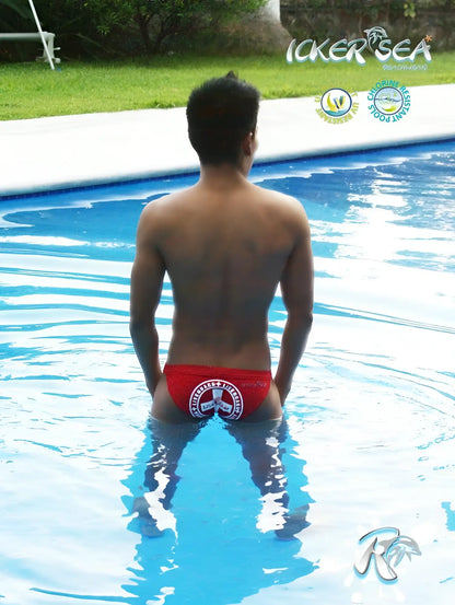 Red icker sea lifeguard micro slip bikini swimwear showing the back side with white circular logo on swim trunks