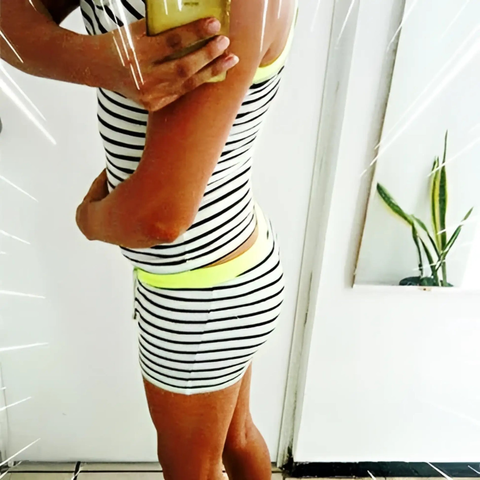 Black and white striped athletic shorts with neon yellow waistband paired with icker sea stripe lines tank top pearl black