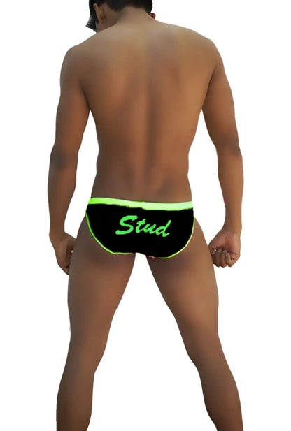 Black swim trunks with neon green trim and stud lettering from icker sea stud slip bikini underwear black green