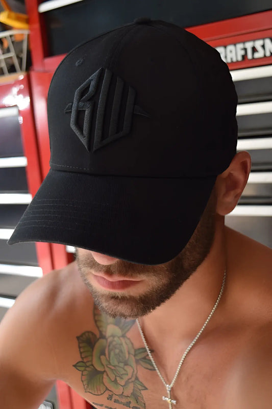 Black baseball cap with subtle raised geometric logo embroidered in matching black thread, ICON cap black