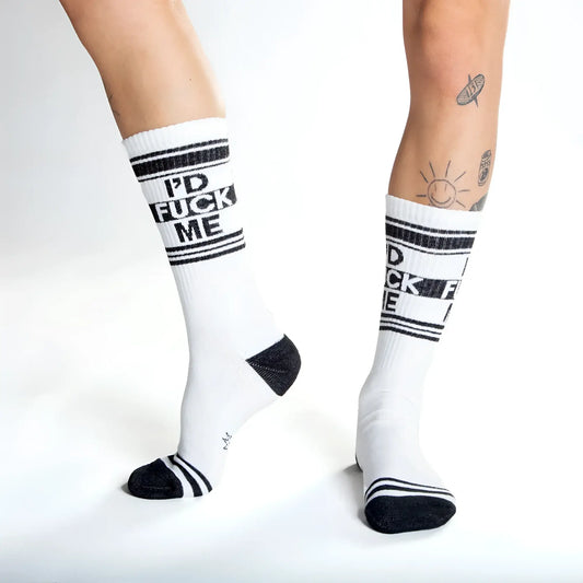 White crew socks with black text id fuck me and matching black stripes toe caps and heel accents for casual wear
