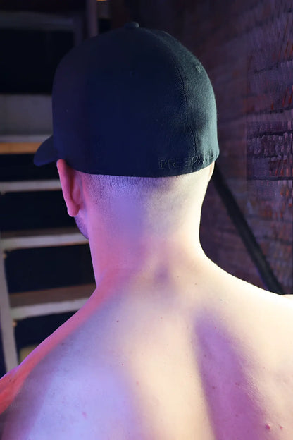 Black baseball cap with subtle embroidered logo on the back showing the Illuminator Icon Hat design