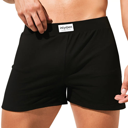 Black cotton boxer briefs with a white intymen brand label on the waistband inc003 model