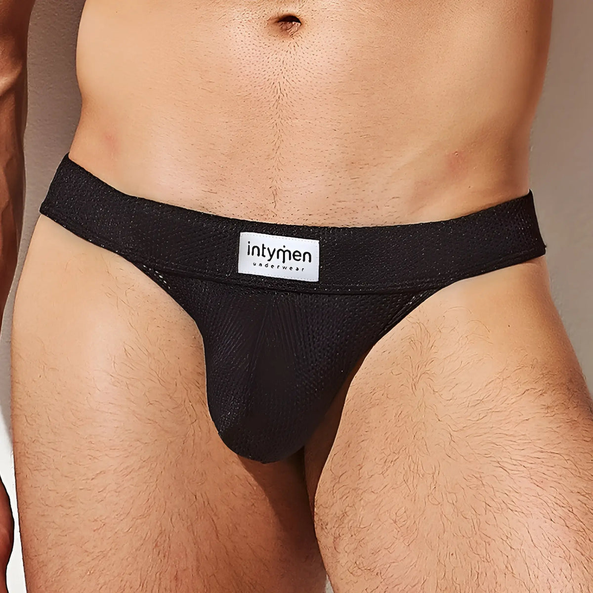 Black textured mesh briefs jockstrap with white intymen underwear label on waistband from intymen ine028 collection