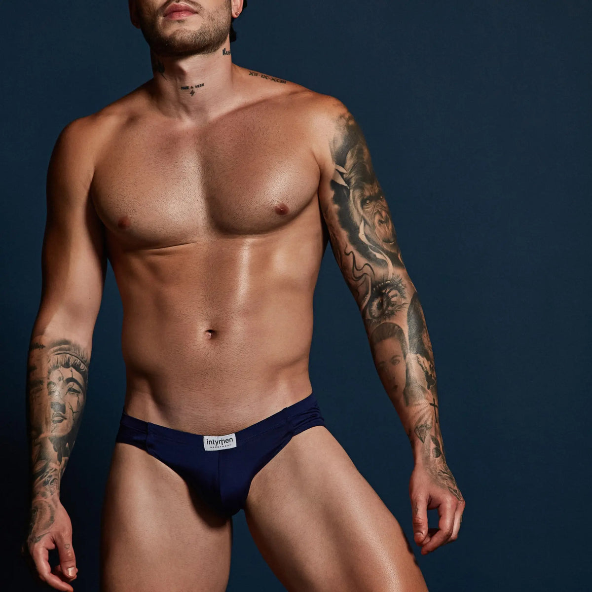 Navy blue Intymen INE035 jockstrap briefs with white waistband label designed for athletic support and comfort
