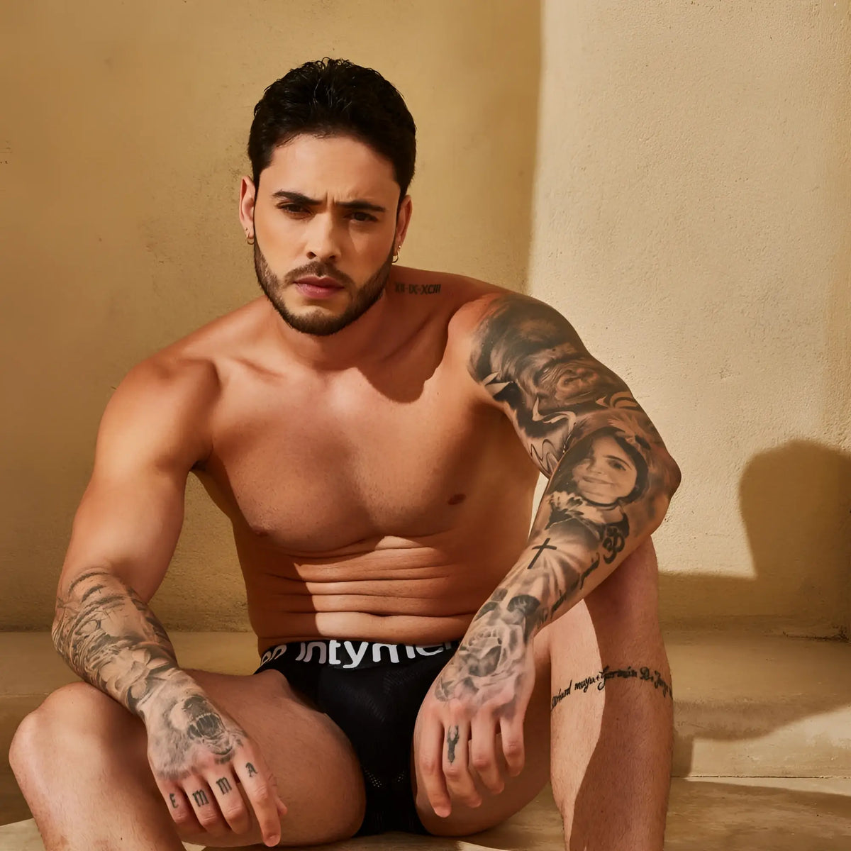 Black briefs with white intyner branding from intymen ing096 boxer featuring comfortable stretch fabric