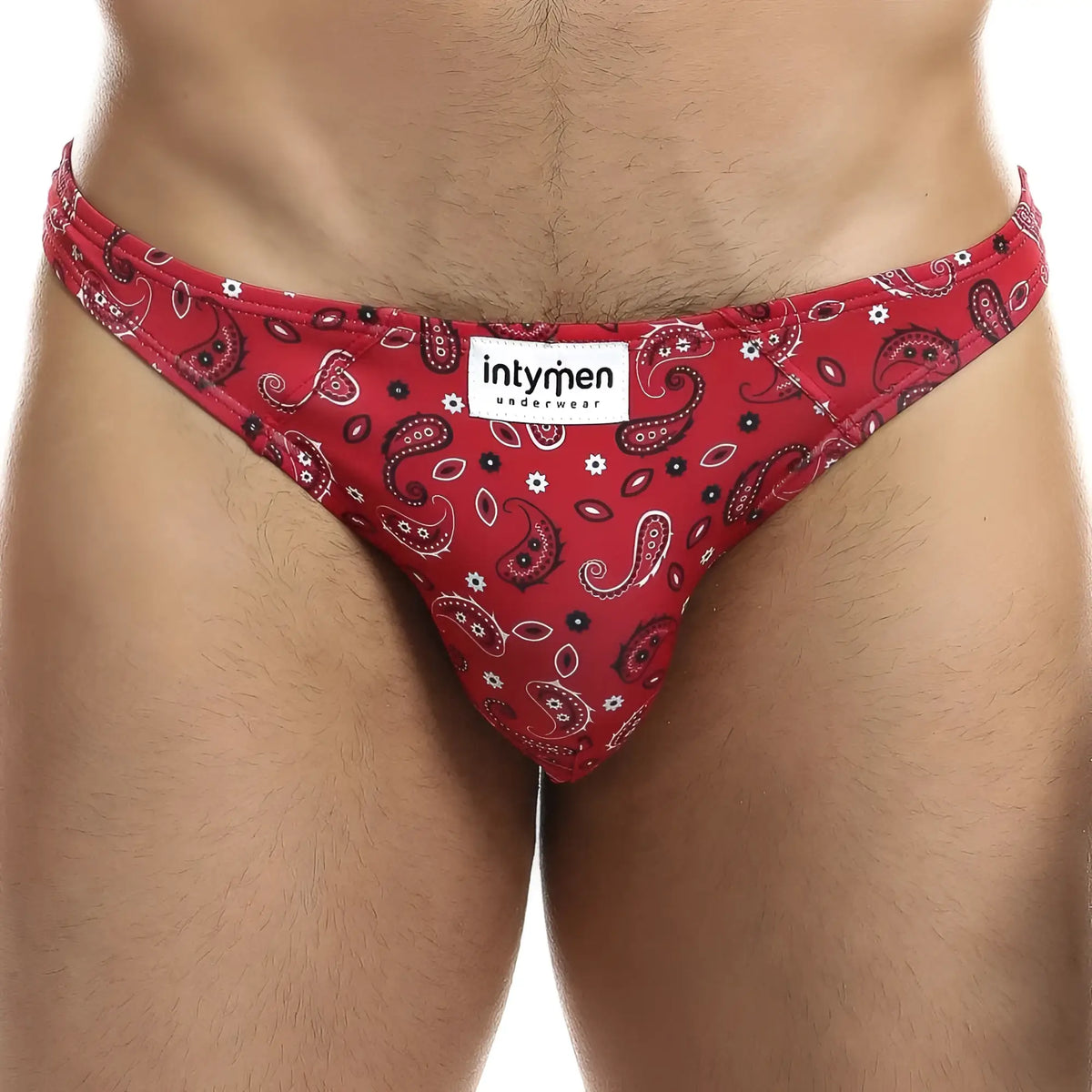Red paisley-patterned menâ€™s bikini briefs with black and white accents featuring intymen underwear brand label