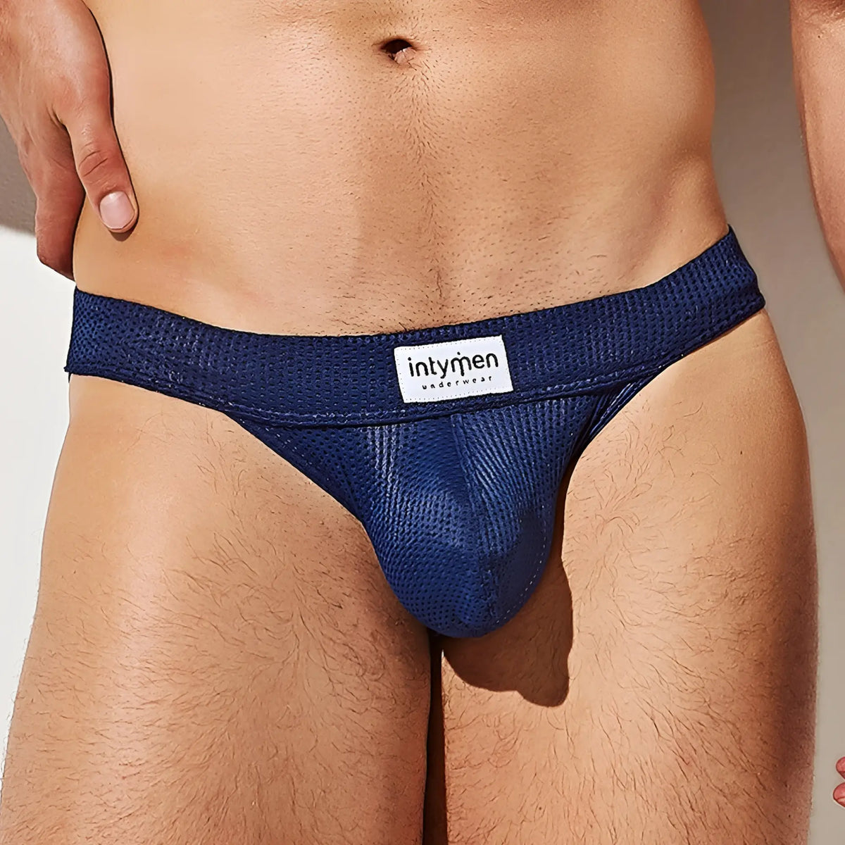Navy blue textured mesh Intymen INI037 bikini brief with white Intymen underwear label on the waistband