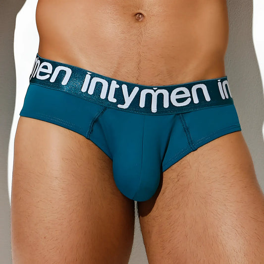 Teal menâ€™s briefs with a glittery waistband featuring intymen branding in white lettering intymen inj066 brief