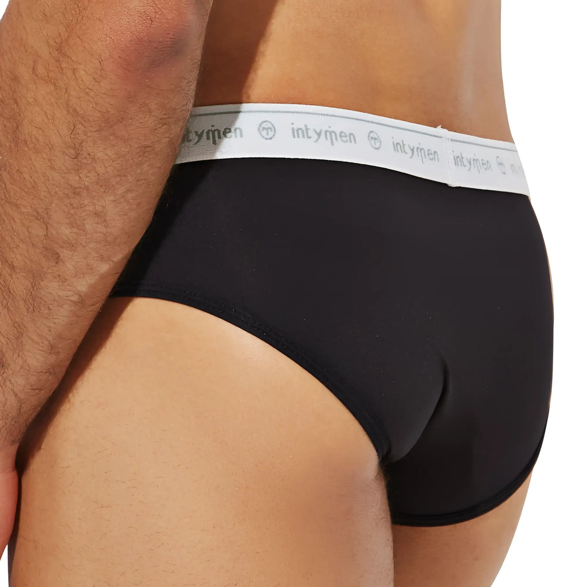 Black intymen inj088 briefs with white elastic waistband featuring intyren logo repeated along its length