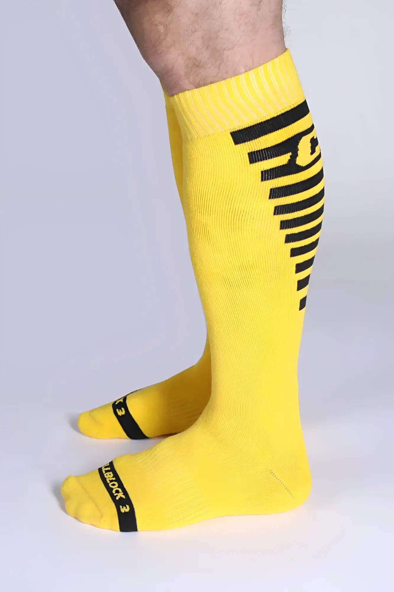 Iron grip knee high socks bright yellow with bold black stripes and reinforced toe caps for durability