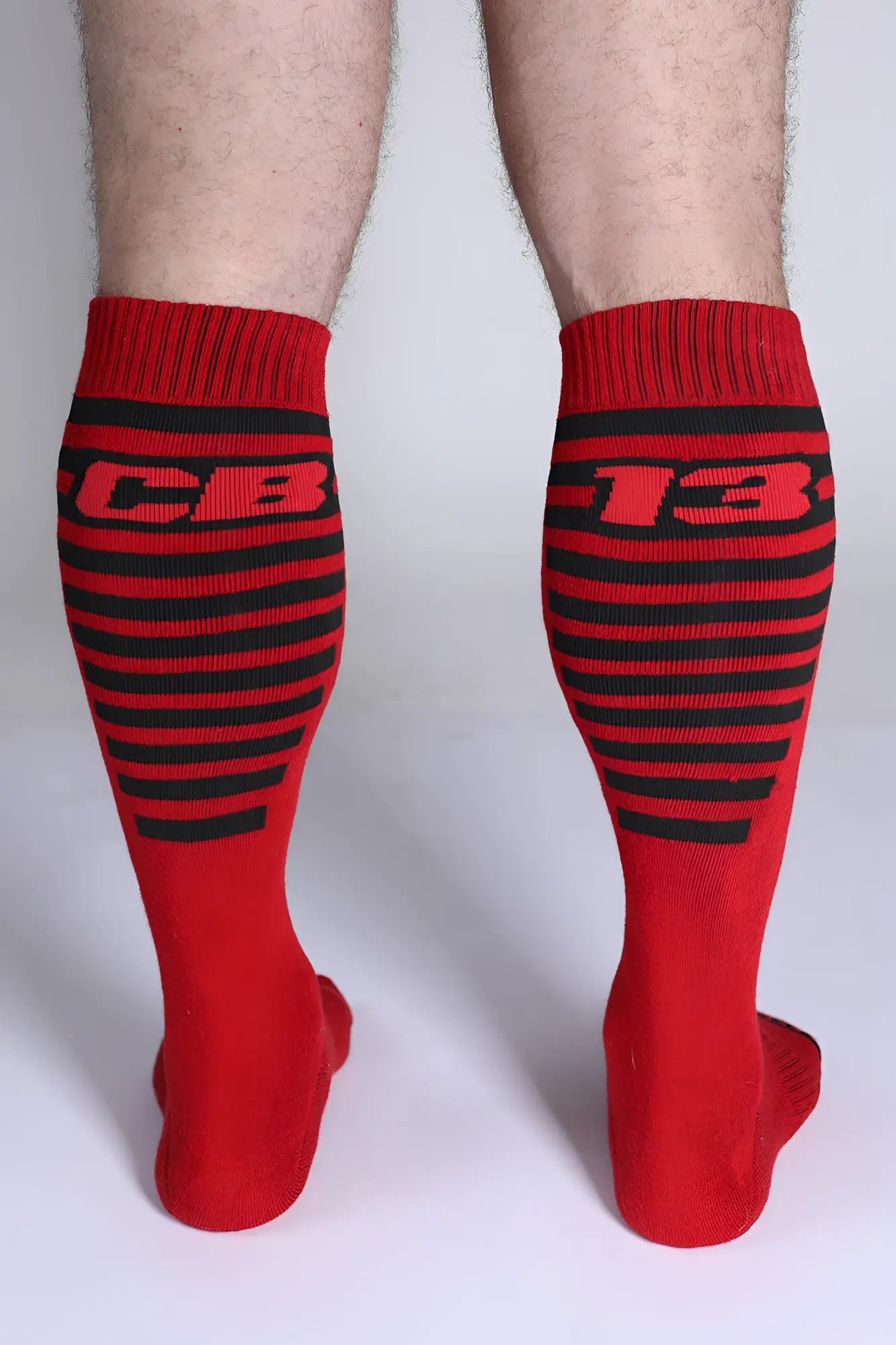 Iron Grip knee high socks in red with black stripes and bold cb 13 lettering on the upper leg