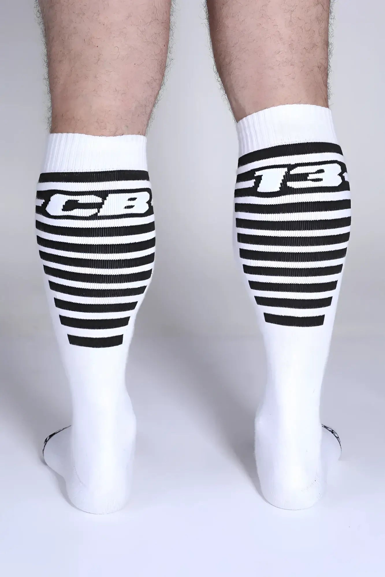 Iron grip knee high socks in white with black horizontal stripes and bold cb or 13 lettering on the upper leg