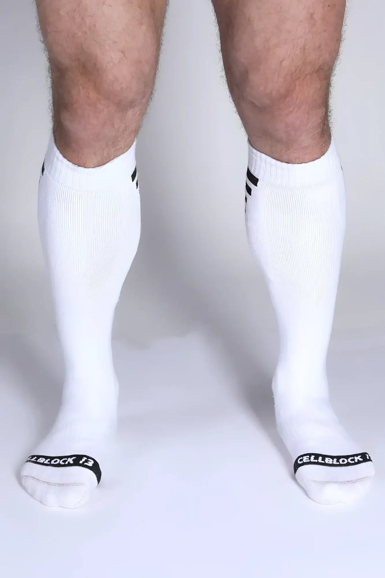 Iron Grip knee high socks in white with black striped cuffs and cellblock 13 branding on the toe