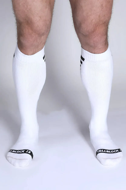 Iron Grip knee high socks in white with black striped cuffs and cellblock 13 branding on the toe
