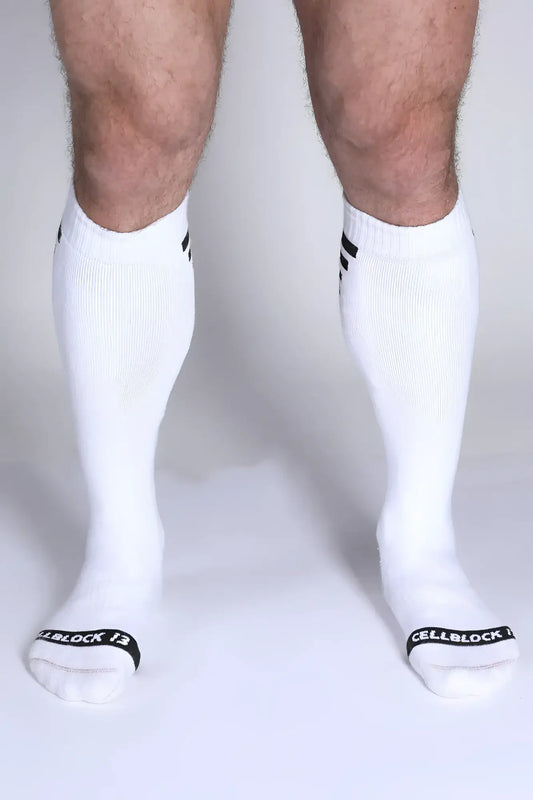 Iron Grip knee high socks in white with black striped cuffs and cellblock 13 branding on the toe
