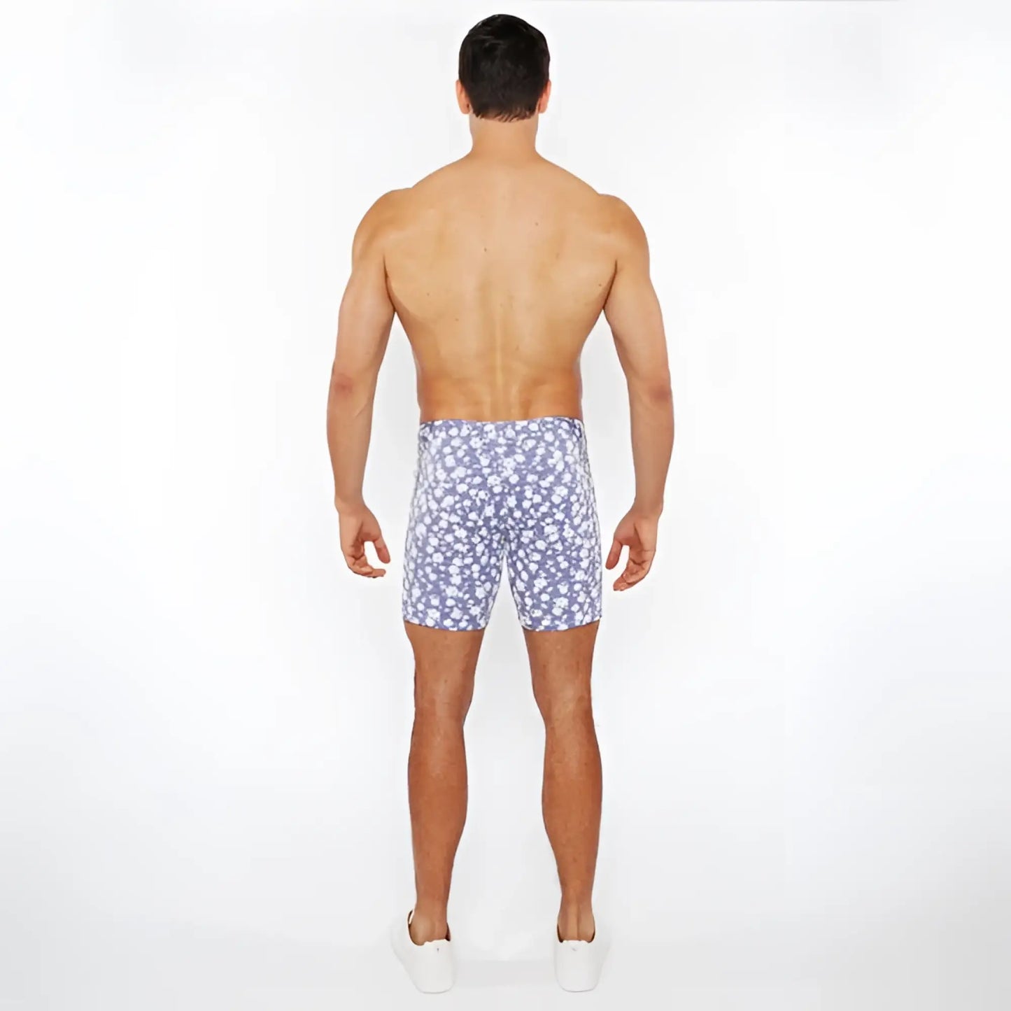 Jaquard stretch knit shorts featuring blue and white floral patterned swim trunks made from stretchy knit fabric