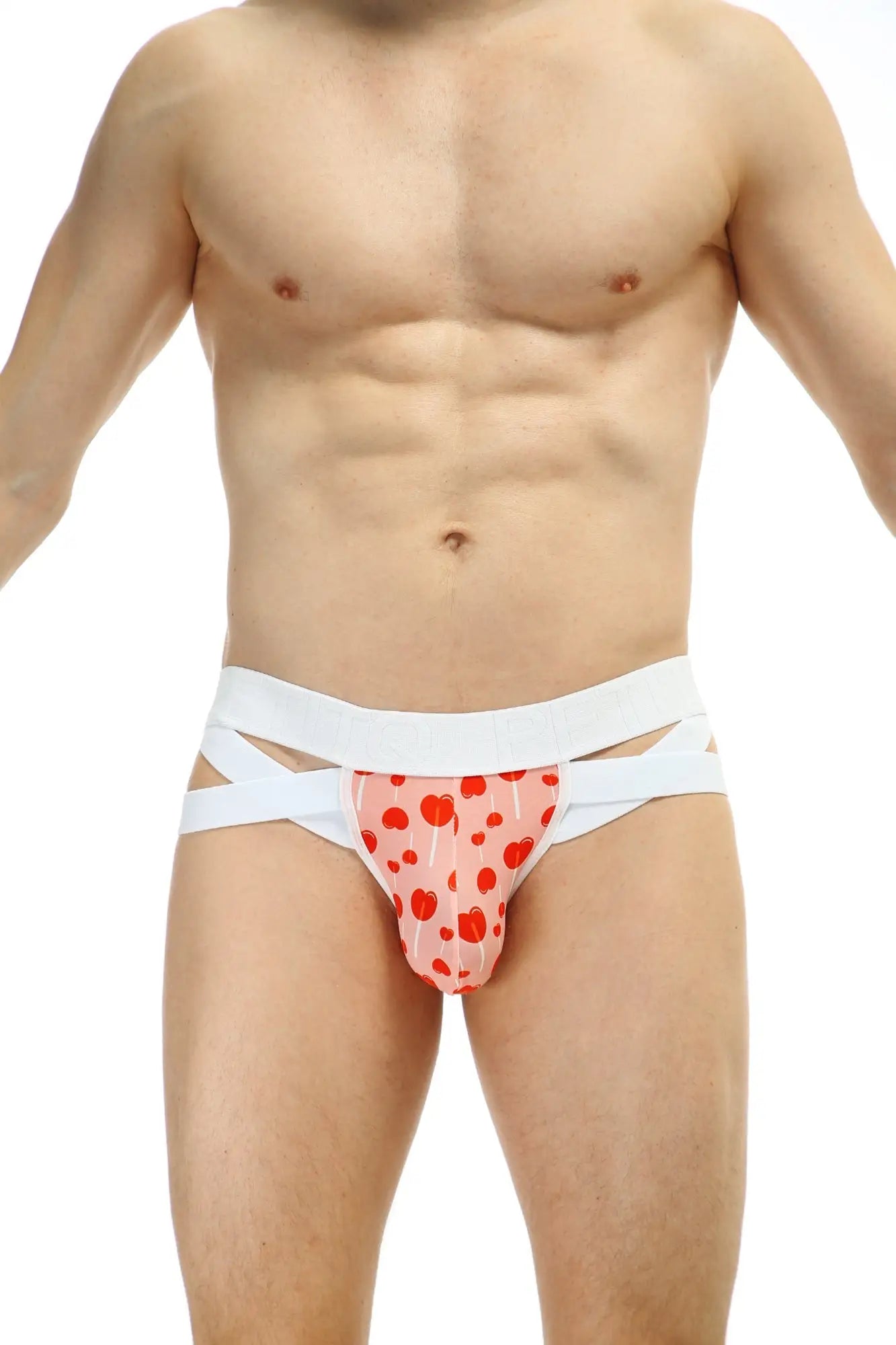 Pink heart patterned jockthong bost sucette briefs with white crisscross straps showing front side
