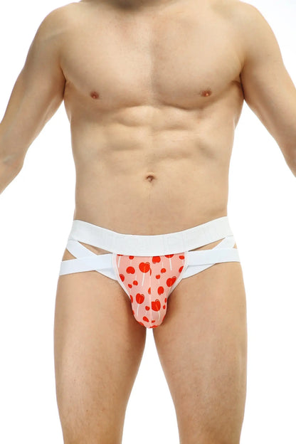Pink heart patterned jockthong bost sucette briefs with white crisscross straps showing front side