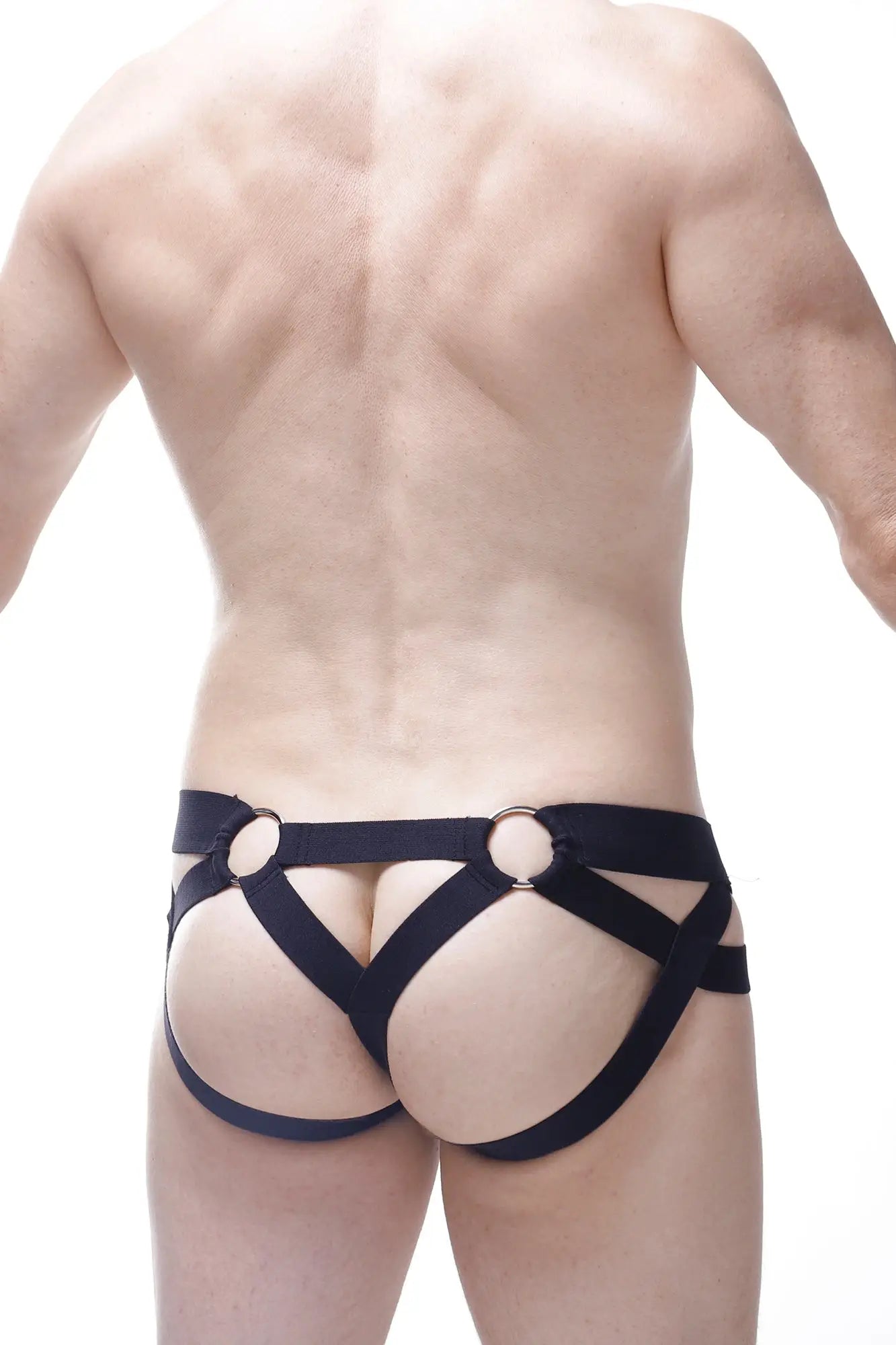 Black leather harness-style jock thong with metallic rings in post bee black shown from the back side
