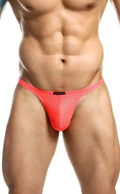 Bright pink joe snyder holes thong mesh briefs with perforated design and small black brand tag visible