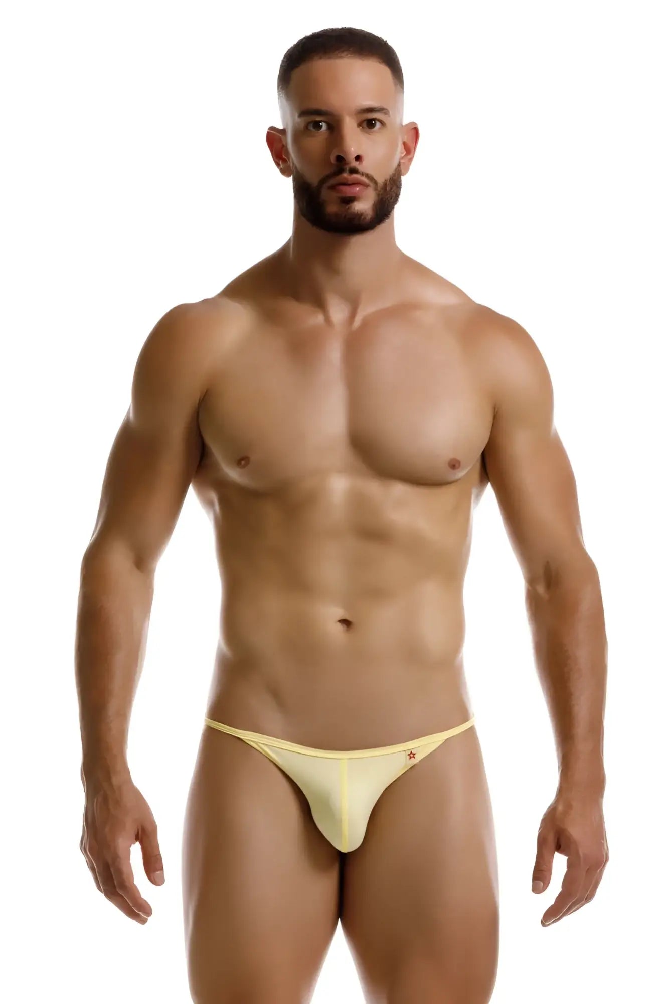 A pale yellow form-fitting jor 2258 axel g-string thong with a subtle red logo on the left hipband