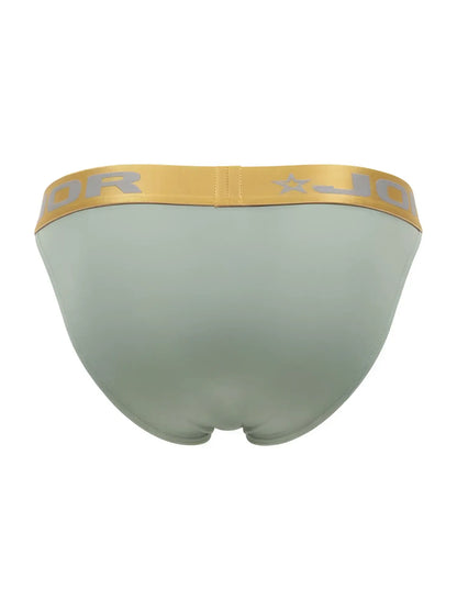 A sleek light green jordan men’s brief with a gold waistband and silver logo from jor 2328 soho bikini collection