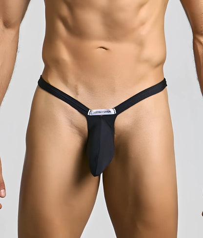 Black justin simon bulge thong with sleek form-fitting design and white brand label at the center