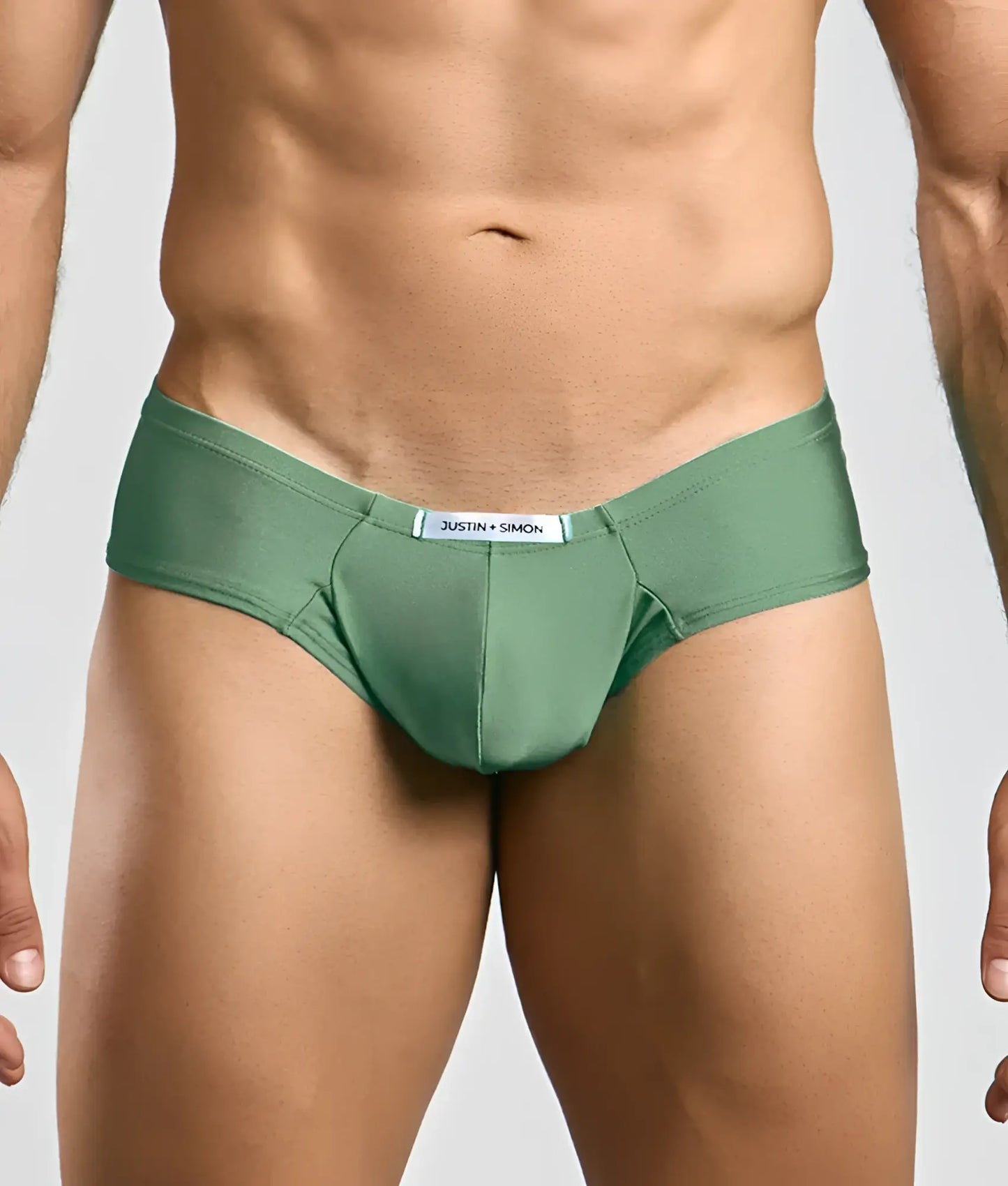 Green justin simon cheek briefs with smooth form-fitting fabric and white label on the waistband front side